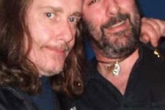 Alabama 3's Very Rev D Wayne Love gives Dave his blessing after a show with the band